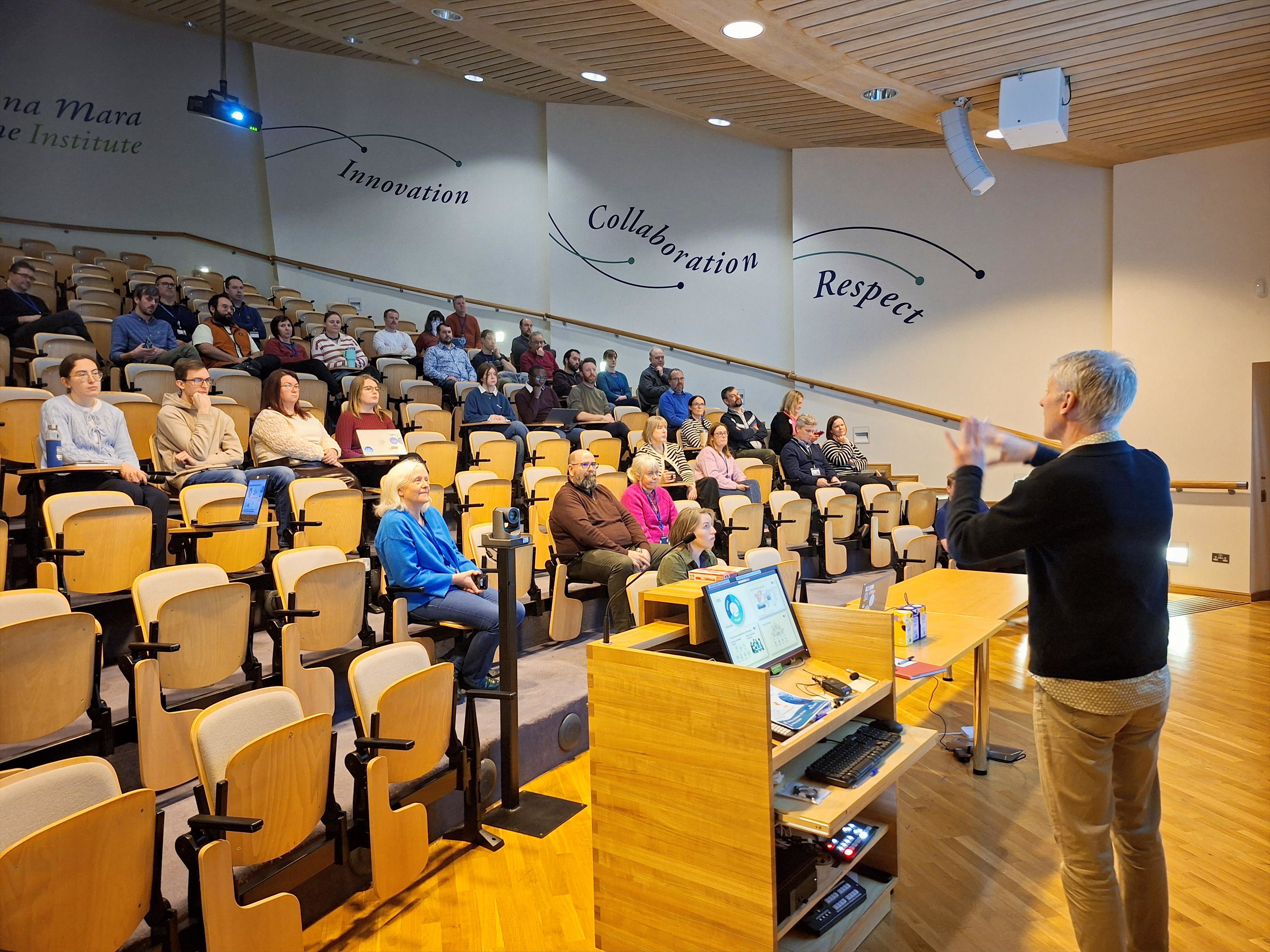 Social gathering at the auditorium with a man presenting to the audience