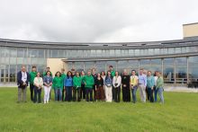 A group photo of bursars and supervisors on the background of the Marine Institute Headquarters